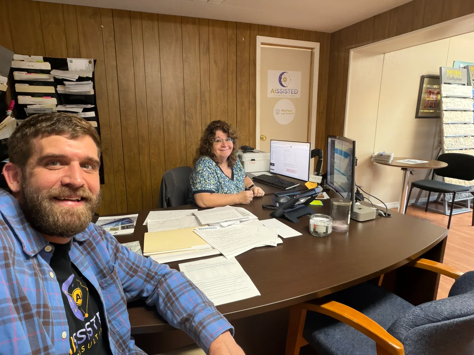PJ taking a selfie with Donna at her desk in the office.